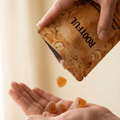 Hand catching ROOTFUL ACV & Kombucha gummies poured from pouch – sugar-free apple cider vinegar gummies close-up